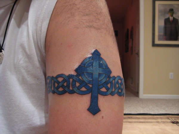 Cross on celtic band tattoo