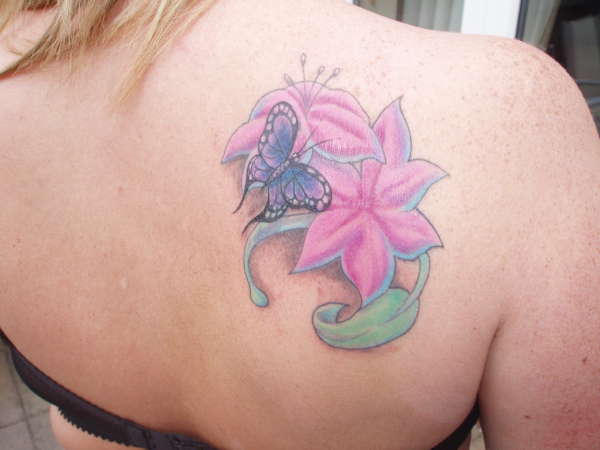 Flower and butterfly cover up tattoo