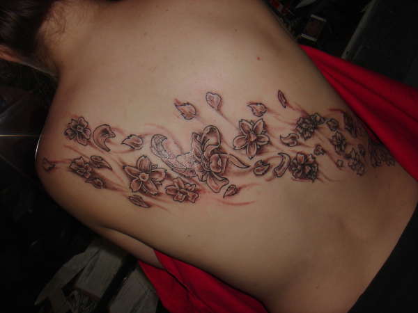 Flowers across the back tattoo