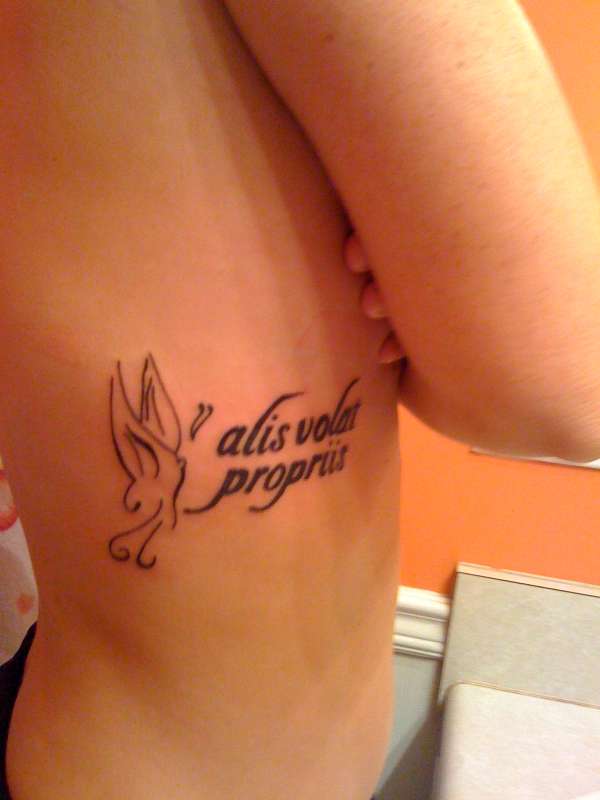 She flies with her own wings (Latin) tattoo