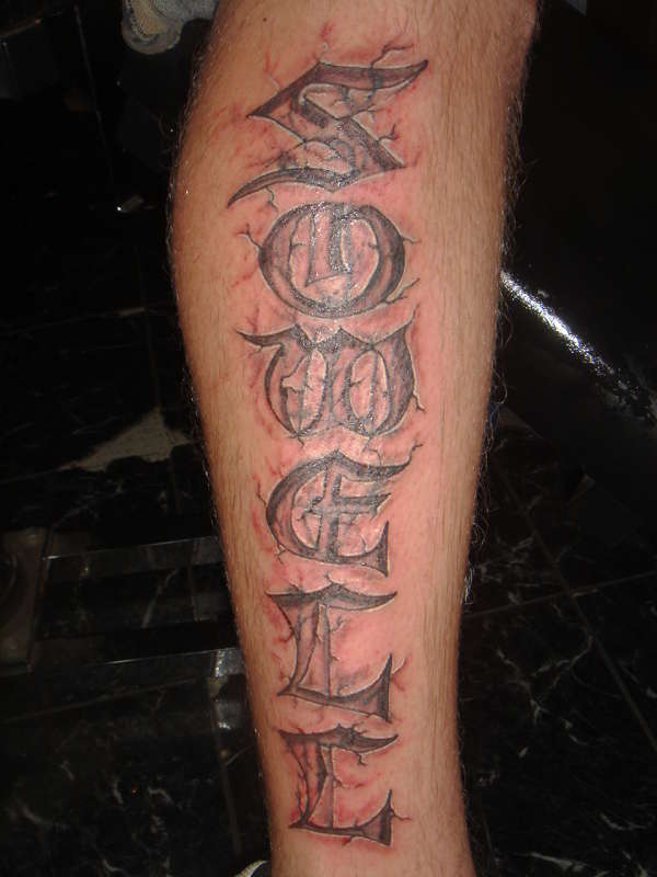 name carved in stone tattoo