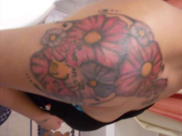 flowers and letterin tattoo