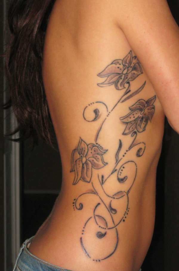 tiger lilies on ribs tattoo