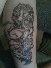 a demon crushing another my art tattoo