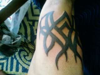 tribal on right thigh tattoo
