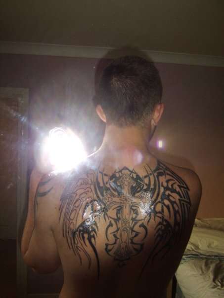 Tribal wings with cross tattoo