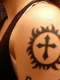 tribal sun & cross tattoo