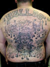 chicano style backpiece tattoo