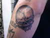 skull on elbow tattoo