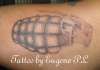 Hand grenade on bicep tattoo