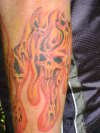 Flaming skulls tattoo