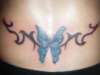 butterfly with tribal on lower back tattoo