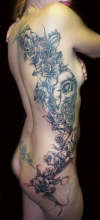flowers and skulls tattoo