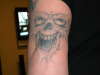 skull on elbow tattoo