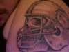 Skull wearing a Miami Dolphin Helmet (face) tattoo