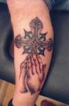 hands and cross tattoo
