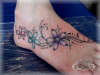 Stylised flowers on foot tattoo