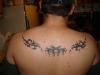 tribal across shoulders tattoo