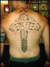 "INRI" in smoke across a wood cross fused to my spine. tattoo