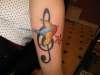 Swallow and treble clef tattoo
