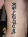 last name rib tattoo