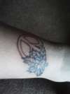 peace sign and pot leaf tattoo