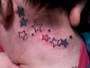 Kristins stars behind her ear tattoo