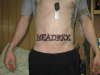 Last name on stomach tattoo
