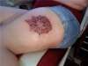Lotus flower on left thigh tattoo