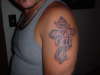 Q's cross tattoo