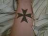 Left wrist maltese cross tattoo