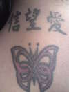 tribal butterfly and chinese writing tattoo