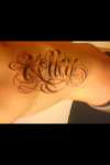 last name on ribs tattoo