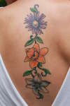 3 flowers on back tattoo