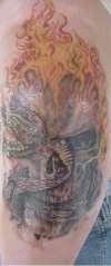 Skull on fire with a snake tattoo