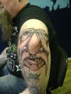 face on elbow tattoo