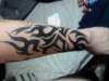 Tribal colored in black w/ blue tips tattoo