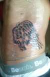 Winged Microphone tattoo