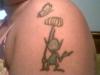 alien holding a flower tattoo