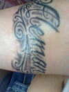Last Name on right arm tattoo