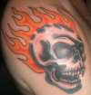 Skull and flames tattoo