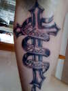 Under arm cross tattoo
