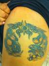 dragon holding planets tattoo