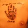 Tattoo of Babys handprint with name and date of birth tattoo