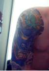 Full colour,half sleeve hannya mask plus lotus flowers and waves tattoo