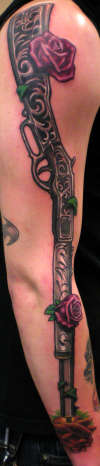 Rifle on arm by Beto Munoz of Monkeyproink.com tattoo