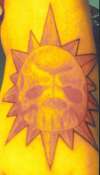 sunskull on foot tattoo
