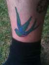 swallow with matching on the other side of leg tattoo