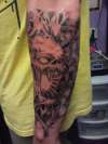Skull arm sleeve tattoo