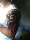 Tribal cover red black tattoo
